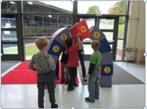 Students build an arch out of foam blocks.