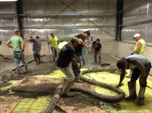 A crew of volunteers helps to lay the ice mat during the rebuilding.