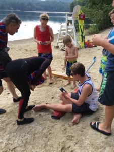 Lifeguard Jake Green, sitting, first noticed the turtles hatching.