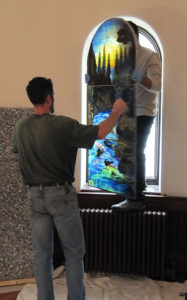 Experts carefully remove the cracked Sunrise window for repairs.