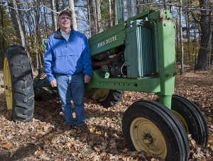 Jim Stotler with a 1950s John Deere tractor that he plans to renovate. Photos by Bruce Frisch.