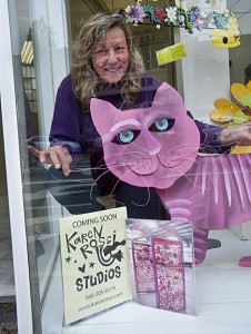 Karen Rossi, setting up her new window displays at 27 E. Main Street in Torrington.