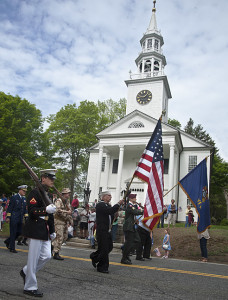 Norfolk's veterans file past the village green. James Stoddard carries the American flag.