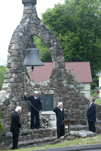 The roll call is read on Memorial Green. Reverend Olsen looks on.