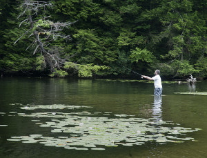 A fisherman casts into the lagoon beside the town beach.