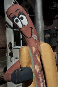 The wooden hot dog out front beckons diners inside.