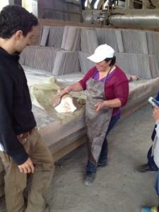 A tile maker at the factory near Bogota discusses the Norfolk tiles.