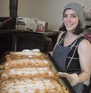 Audrey pulls a fresh sheet of apple strudel from the oven.