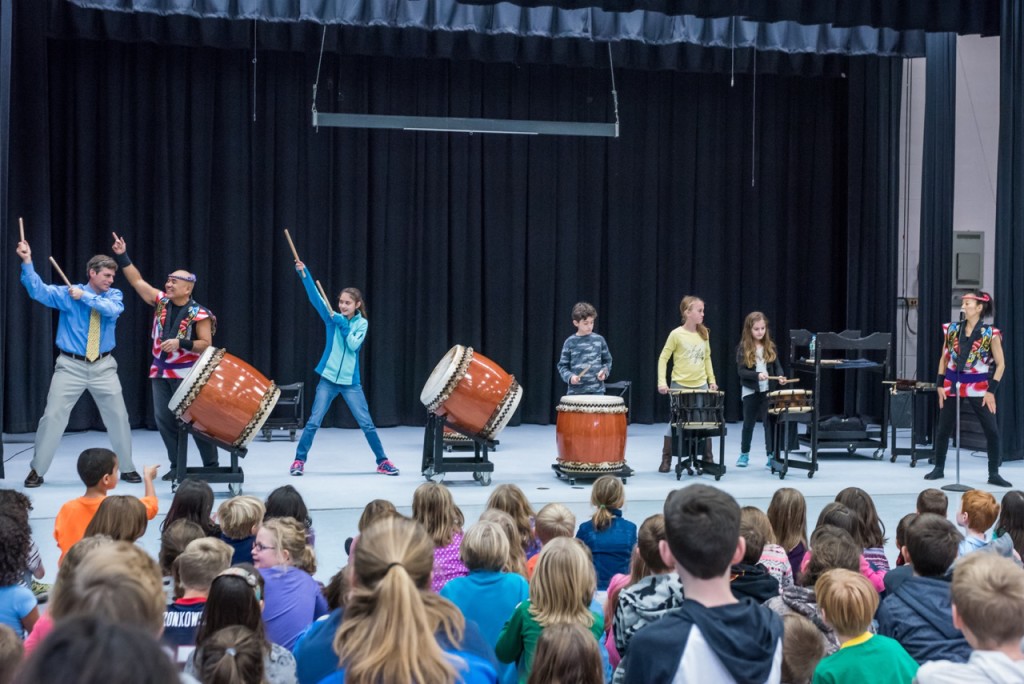 Students join the performers onstage.