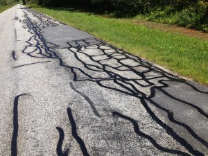 Faithful to its annual ritual, the public works department has been busy this past month sealing Norfolk’s roads before winter. Photo by Wiley Wood.