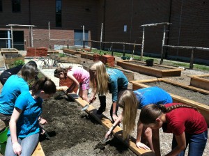 Sixth grade students at Botelle plant their first crop in one of the raised beds.